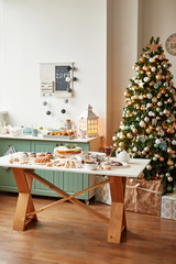 Christmas cake and sweets on table. Christmas  decorations with lights background. Happy New Year! Christmas greeting card. Winter card template. Xmas concept. Holiday Banner. Feast of Nativity. 