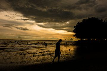 Obraz premium Unrecognizable people and Scenery sunset of Port Dickson beach in Negeri Sembilan