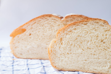 Fresh home made bread on white table background with napkin