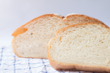 Fresh home made bread on white table background with napkin