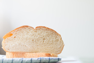 Fresh home made bread on white table background with napkin