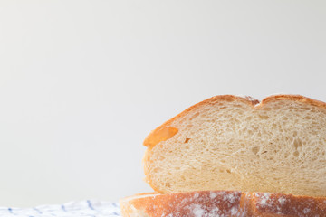 Fresh home made bread on white table background with napkin