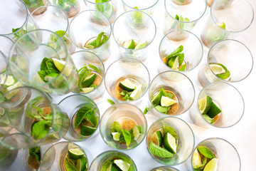 Mojito empty glasses with green leaves, sugar and lime