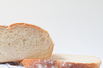 Fresh home made bread on white table background with napkin