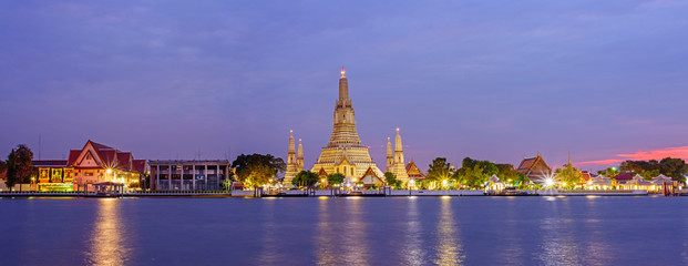 Panorama view of Wat Arun Ratchawararam Ratchawaramahawihan with reflections on the river in sunset time
