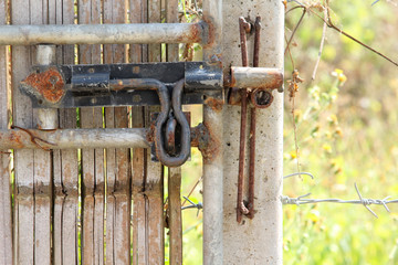 Vintage style rusty bolt on old bamboo door.