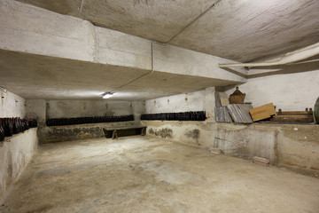 Basement with wine bottles in old house interior