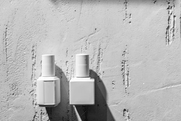 close-up view of white decorative nail polishes on wall in beauty salon