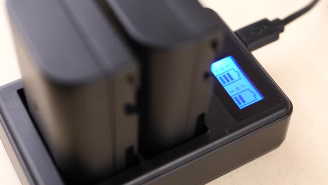 Rechargeable lithium-ion battery with charger for phoro camera