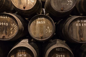 Fotobehang Row of wooden porto wine barrels in wine cellar Porto, Portugal. © Mazur Travel