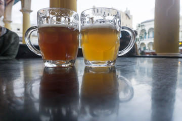 delisiosos glasses of light and dark beer on table