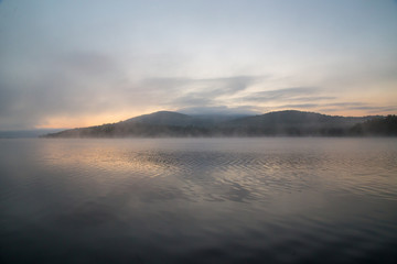 sunset on lake with mountains