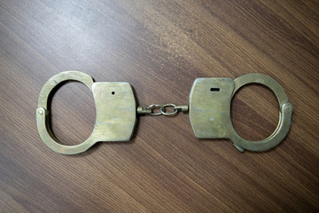 Selective focus on handcuffs on a keyboard cyber crime, hacking, bullying Against law concept in...