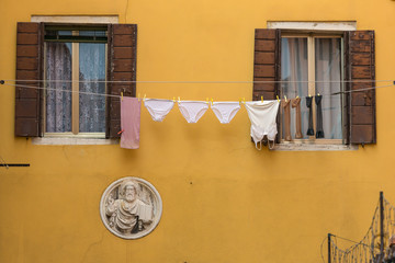 Laundry hanging out of a typical Venetian facade, Venice, Italy