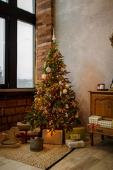 Beautifully decorated Christmas tree with presents under it.