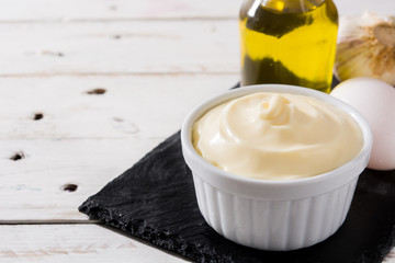Aioli sauce and ingredients on white wooden table
