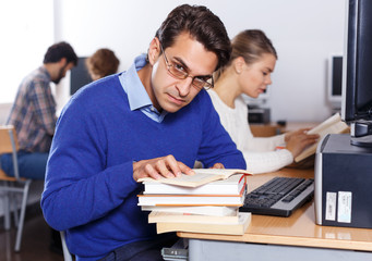  serious man reading books
