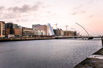 Docklands District in Dublin with a Modern Suspension Bridge Spanning the River Liffey at Twilight