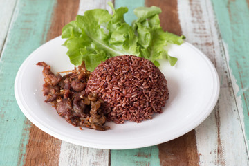 Fried sliced pork with garlic and pepper with purple rice Thai Recipes