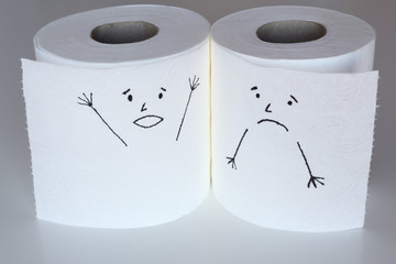 Two white toilet paper rolls sketched with a shouting and a melancholic face, close to each others, representing the panic and the sadness feelings