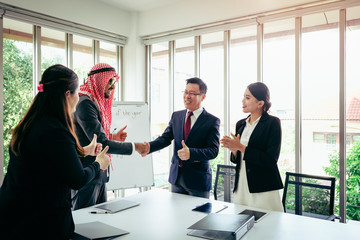 Business meeting Asian team and Arabic man presenting his ideas in office room