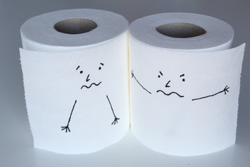 Two white toilet paper rolls sketched with a scared and a angry face, close to each others, representing the fright and the rage feelings