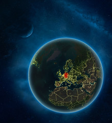 Germany at night from space with Moon and Milky Way. Detailed planet Earth with city lights and visible country borders.