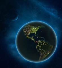 Panama at night from space with Moon and Milky Way. Detailed planet Earth with city lights and visible country borders.