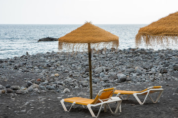 The beach on the Atlantic coast, in the foreground, sun loungers and parasols in the background of...