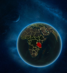 Tanzania at night from space with Moon and Milky Way. Detailed planet Earth with city lights and visible country borders.