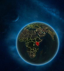 Kenya at night from space with Moon and Milky Way. Detailed planet Earth with city lights and visible country borders.