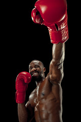 Hands of boxer over black background. Strength, attack and motion concept. Fit african american...