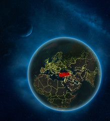 Turkey at night from space with Moon and Milky Way. Detailed planet Earth with city lights and visible country borders.