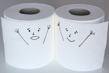 Two white toilet paper rolls sketched with a shouting and a cheerful face close to each other, representing the panic and the happiness feelings