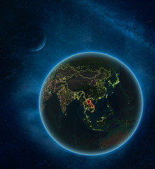 Laos at night from space with Moon and Milky Way. Detailed planet Earth with city lights and visible country borders.