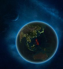 Philippines at night from space with Moon and Milky Way. Detailed planet Earth with city lights and visible country borders.