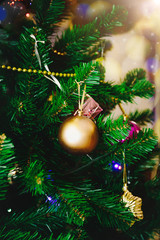 Decorated Christmas tree on blurred background.