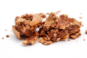 chopped chocolate ball with nuts on white background