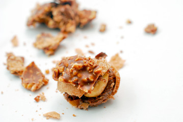 chopped chocolate ball with nuts on white background