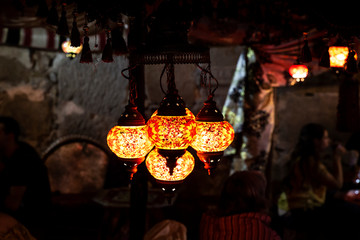 beautiful multicolored arabic lamps glowing at night in a market
