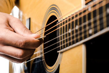 Fototapeta premium partial view of male musician playing on acoustic guitar isolated on white