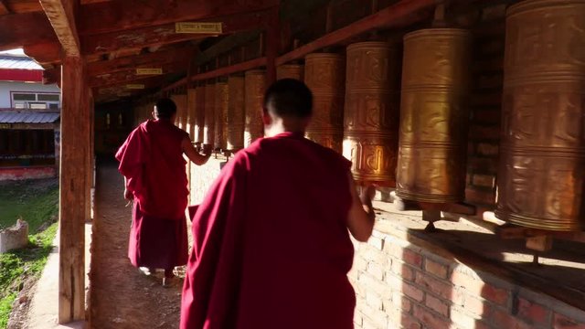 Buddhist monks turning the prayer wheels, Eastern Tibet, China