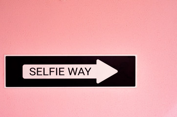 selfie way sign on pink wall