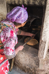 Photograph of how homemade bread is made in a wood-burning oven.