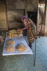 Photograph of how homemade bread is made in a wood-burning oven.
