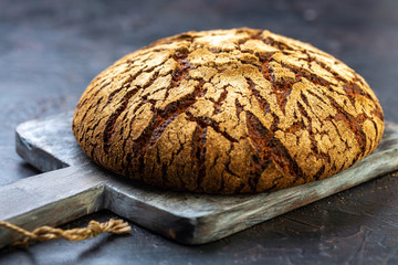Artisanal Finnish rye bread on a wooden board.