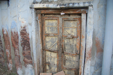 Crooked wooden door of a house in Rajasthan