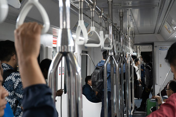 Jakarta, Indonesia - November 2018: People traveling inside monorail wagon in Asia