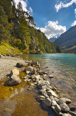 On the bank of a mountain lake Lac de Gaube, Pyrenees Occidentales, France
