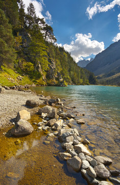 On the bank of a mountain lake Lac de Gaube, Pyrenees Occidentales, France